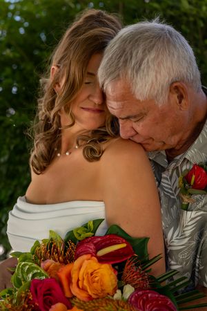 groom kissing bride's shoulder backyard wedding Boise Idaho Milestones Portraits