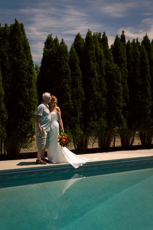 bride and groom posing at pool backyard wedding Boise Idaho Milestones Portraits