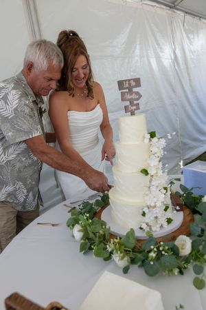 bride and groom cutting the cake backyard wedding Boise Idaho Milestones Portraits