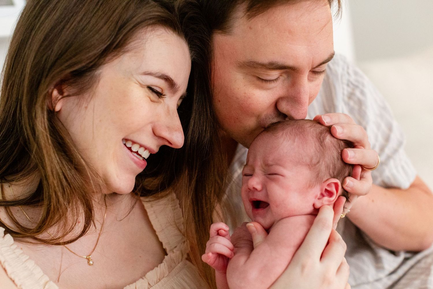 Portrait of a father, mother and newborn. In-home lifestyle newborn session in Guaynabo, Puerto Rico.