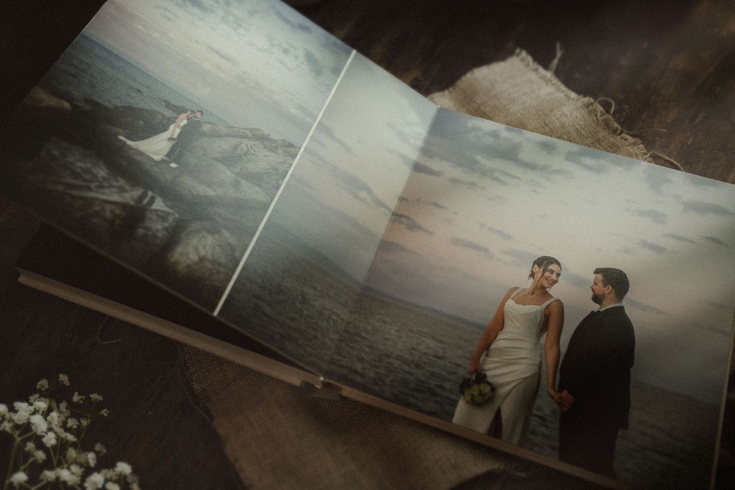 Premium lay-flat wedding photo book open spread showcasing cinematic and moody documentary photography.