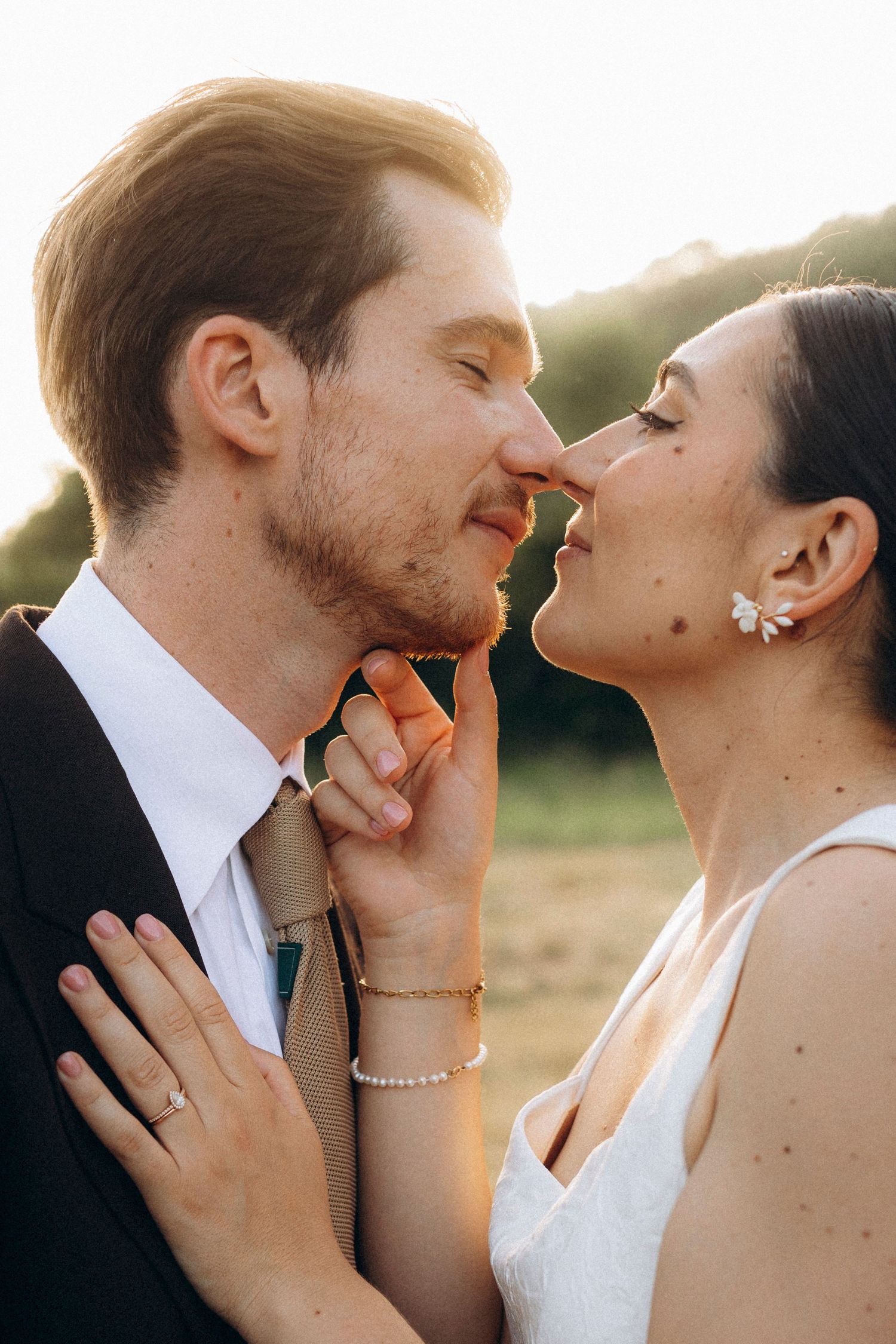 A tender autumn embrace captured during a wedding photoshoot with fall foliage.