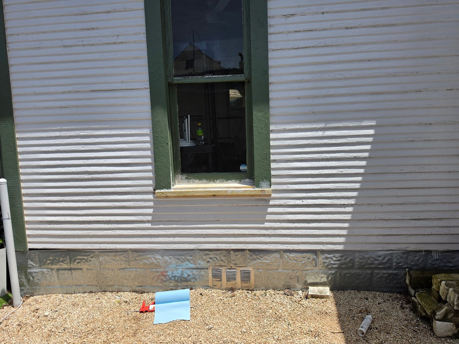 Panoramic exterior view of a rustic cabin with wooden siding and white trim.