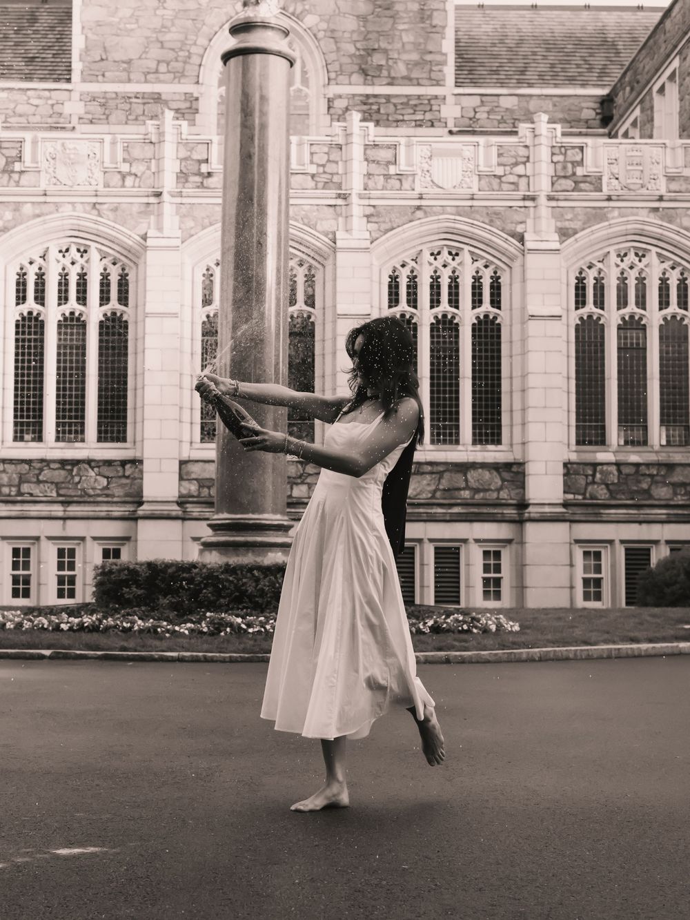 Boston College graduate popping a champagne bottle and celebrating graduation