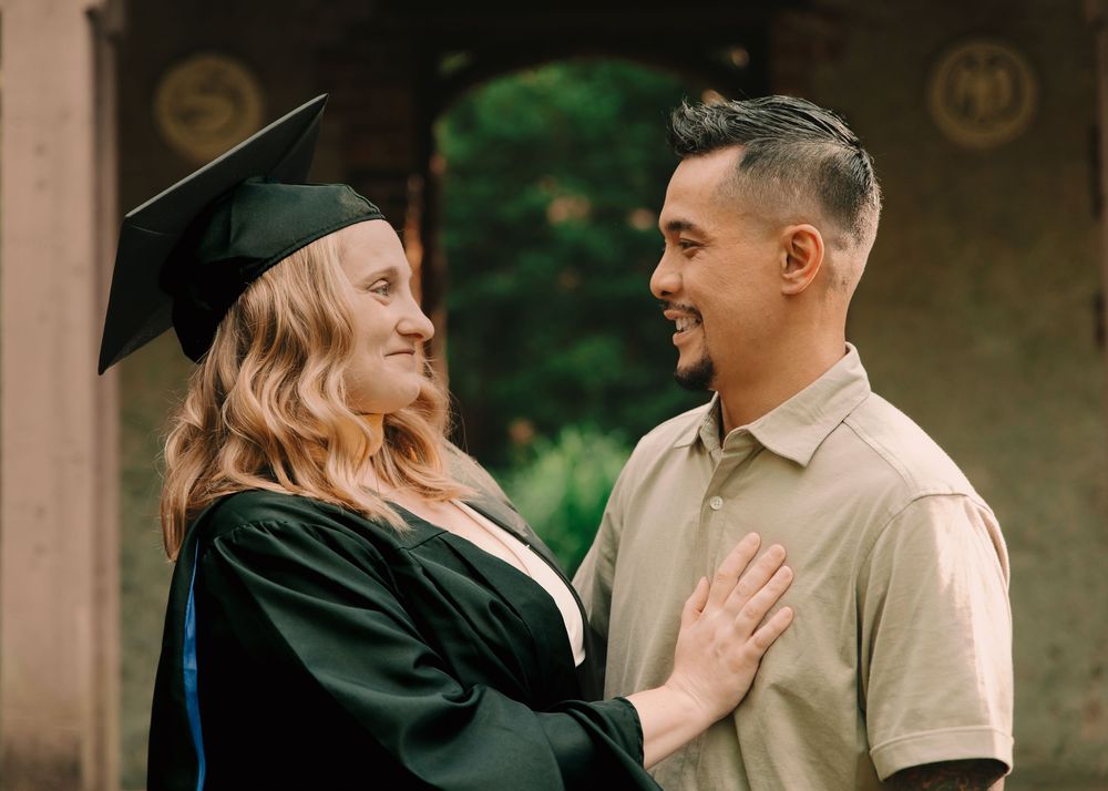 Couple's graduation photoshoot with cap & gown on college campus