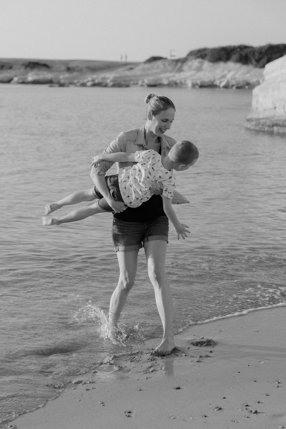 Mother and son playing by the sea in Paphos