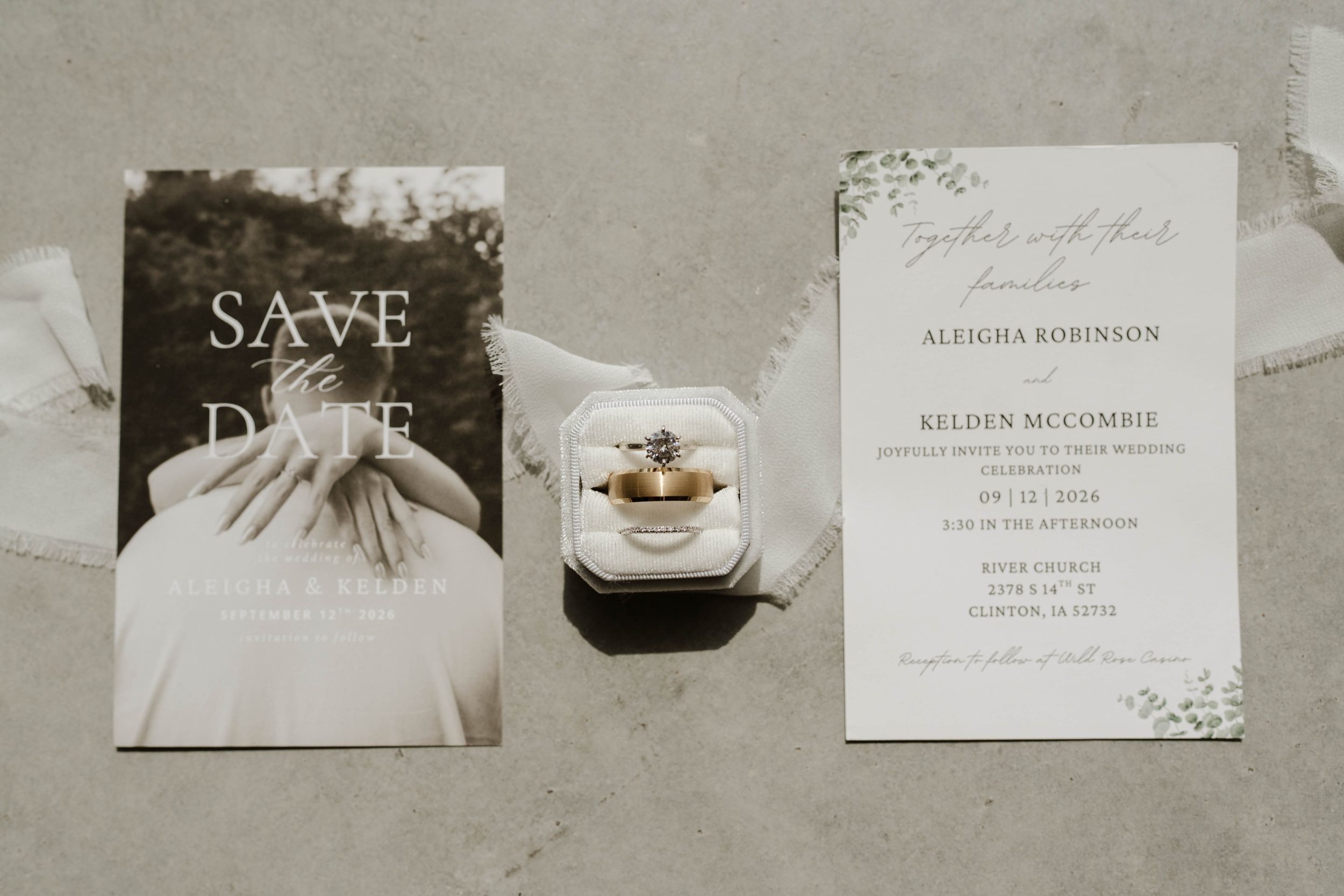 Wedding save the date card and formal invitation for Aleigha Robinson and Belden McCommie displayed with a gold engagement ring.