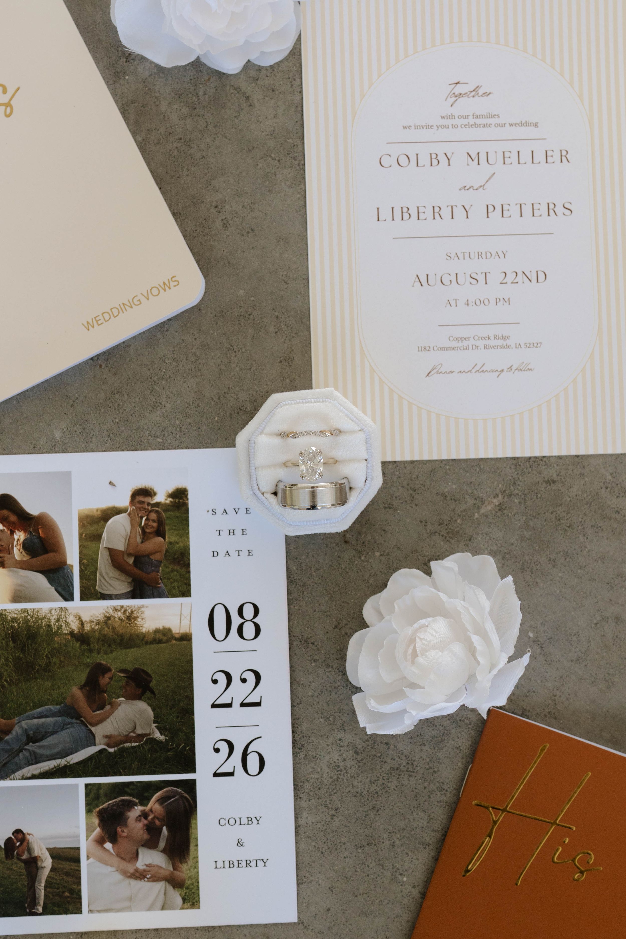 Wedding invitation suite for Colby Mueller and Liberty Peters on August 22nd, featuring save the date cards, rings, and floral accents.