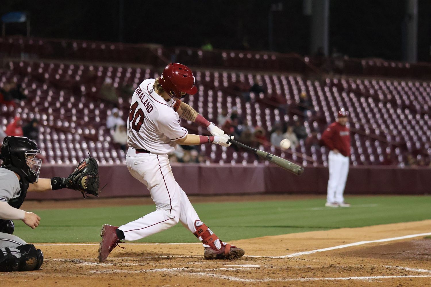 South Carolina baseball batter makes contact with a pitch at home plate.