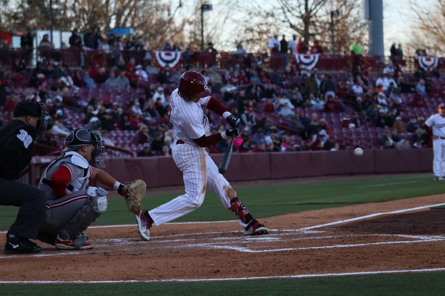 South Carolina baseball batter swings at a pitch in front of the home crowd.