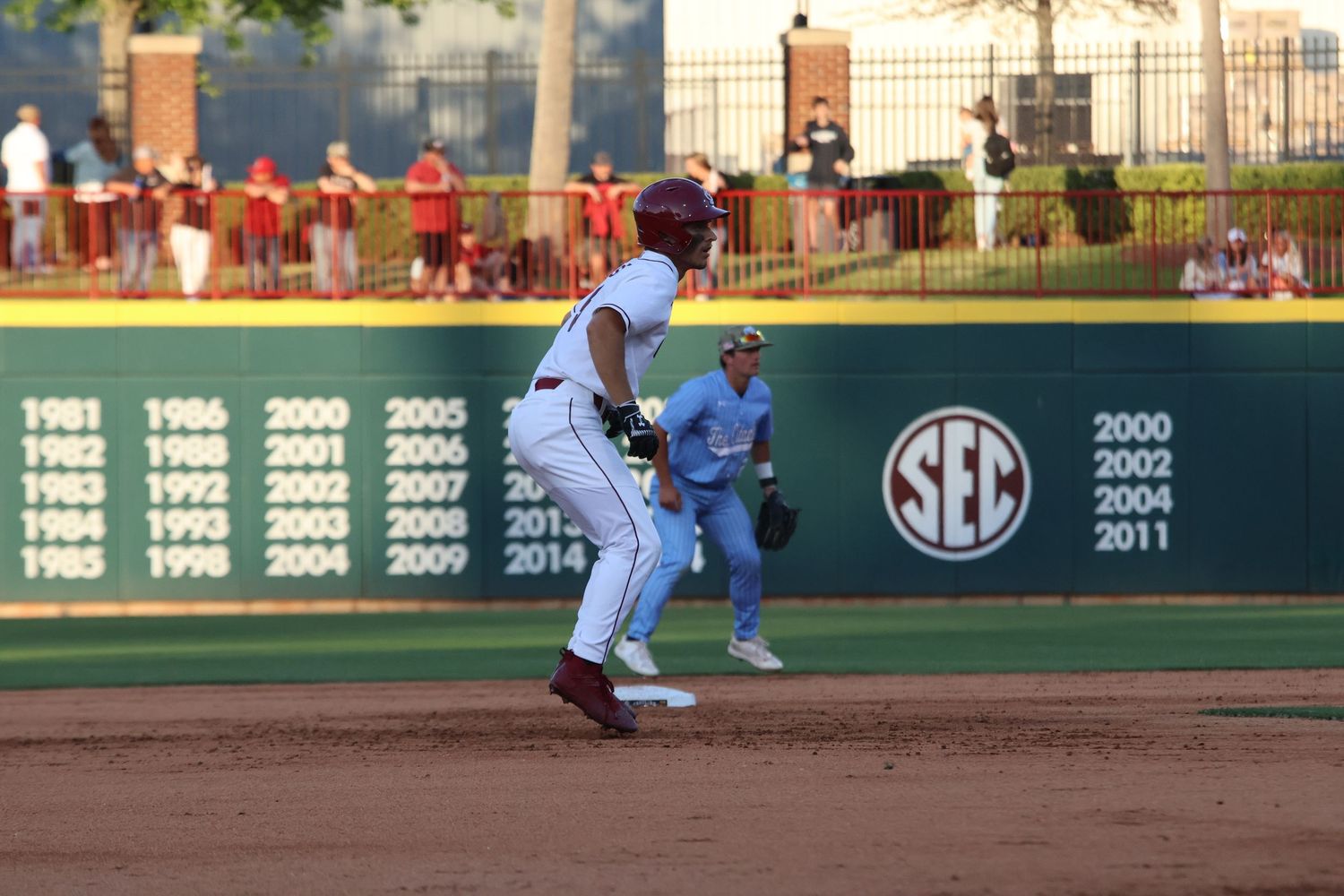 South Carolina infielder prepares to field a throw as a runner approaches the base.