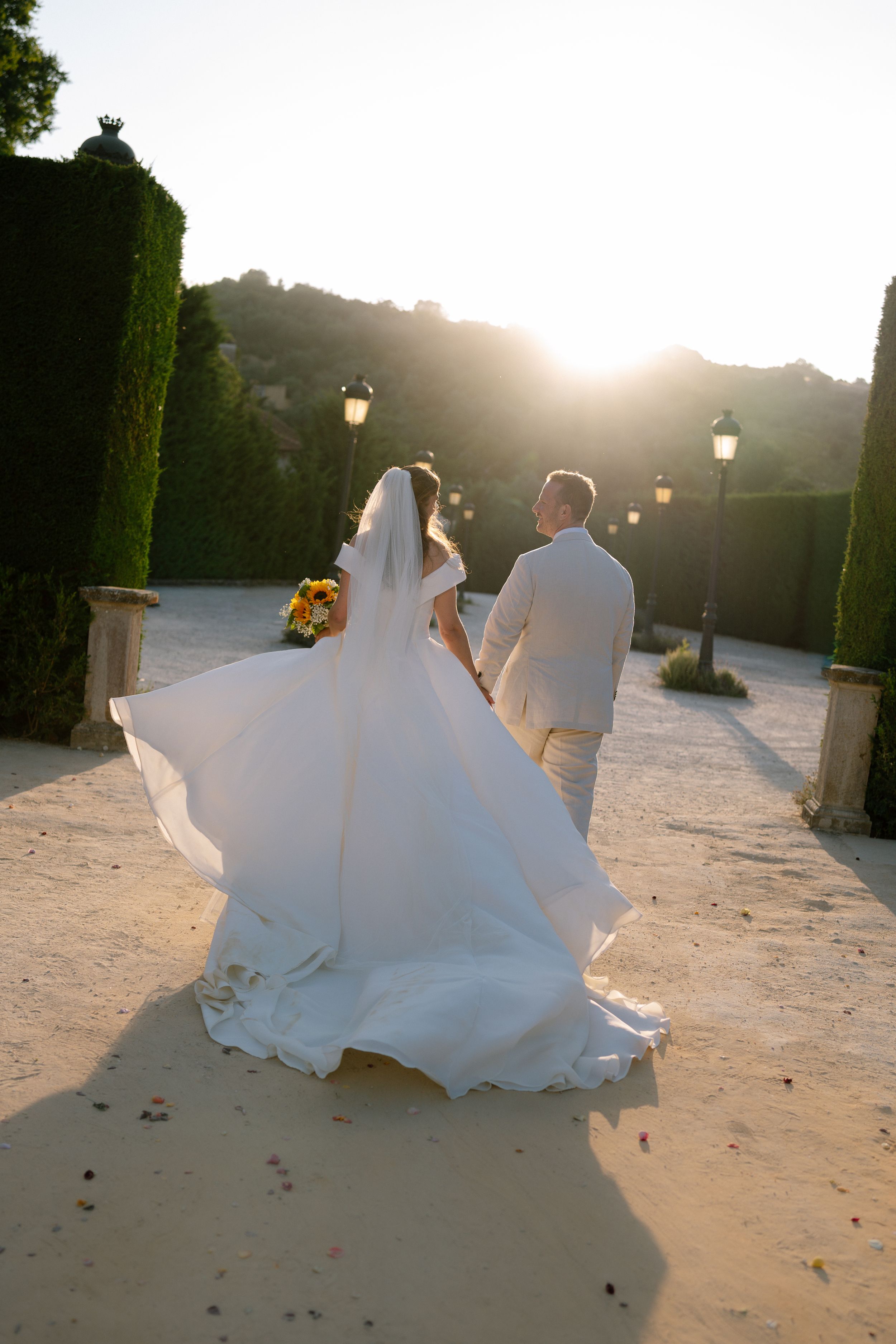 Back light twisted modern photo of bride and groom in Solar de Pancas walking away at golden hour