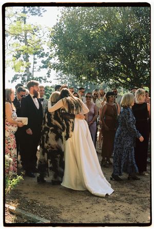 Candid Wedding moment of a bride hugging her mom at vandelli gardens shot on film