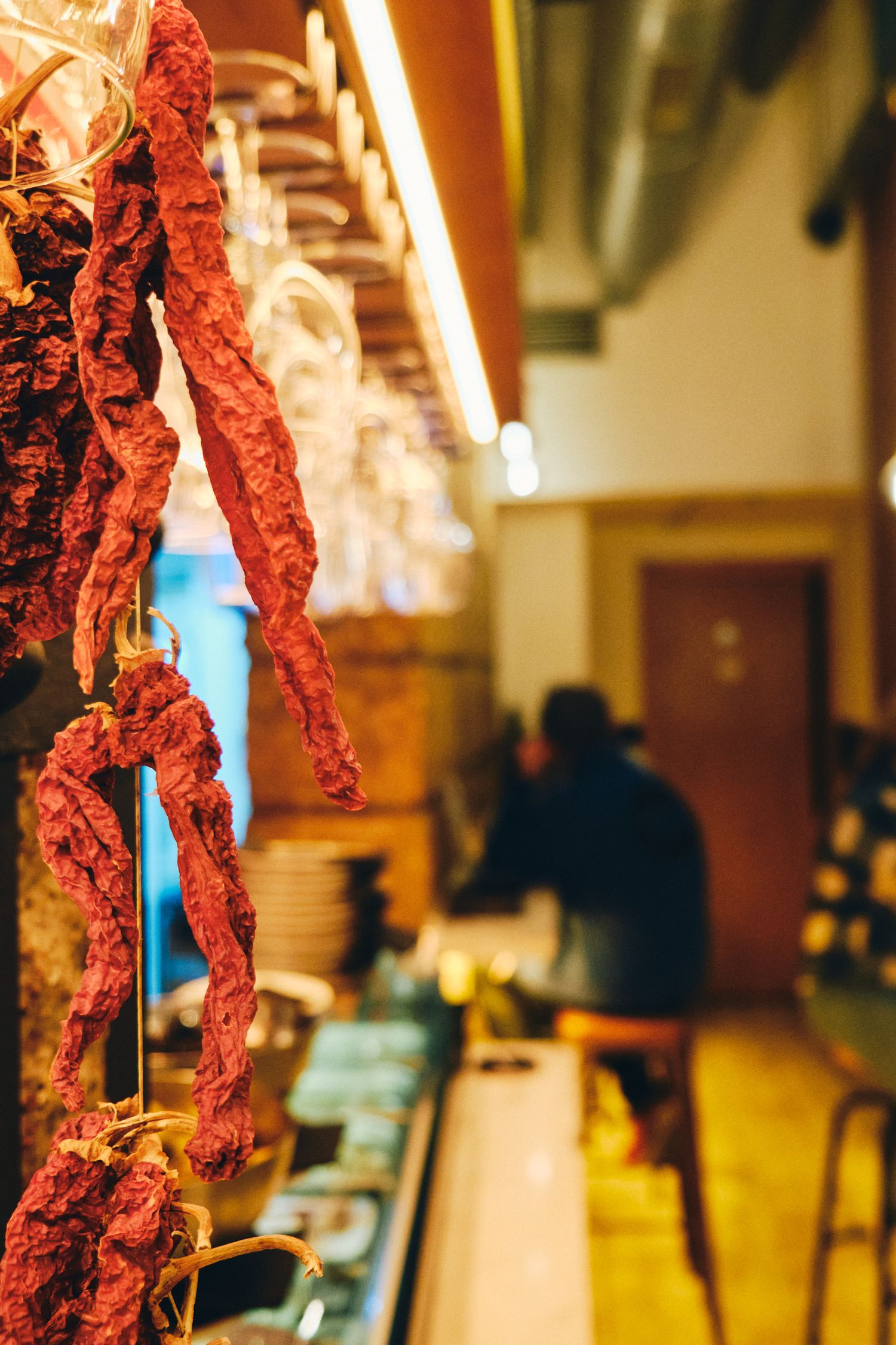 Dried chorizo sausages hanging in a traditional Spanish tapas bar.