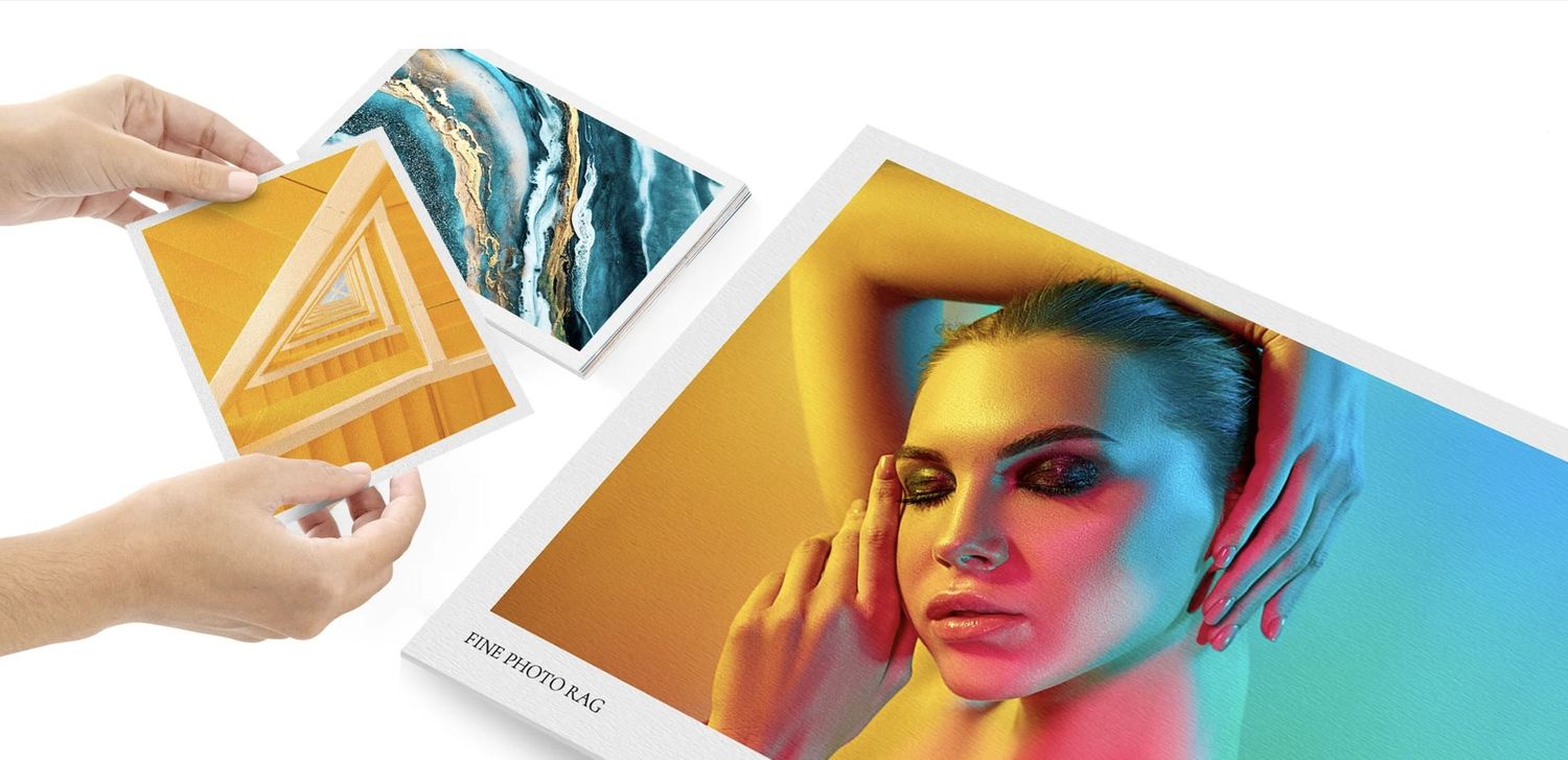 Hands holding fine art photo rag paper next to a large, vibrant professional photo print. Vivitu photo gift premium print