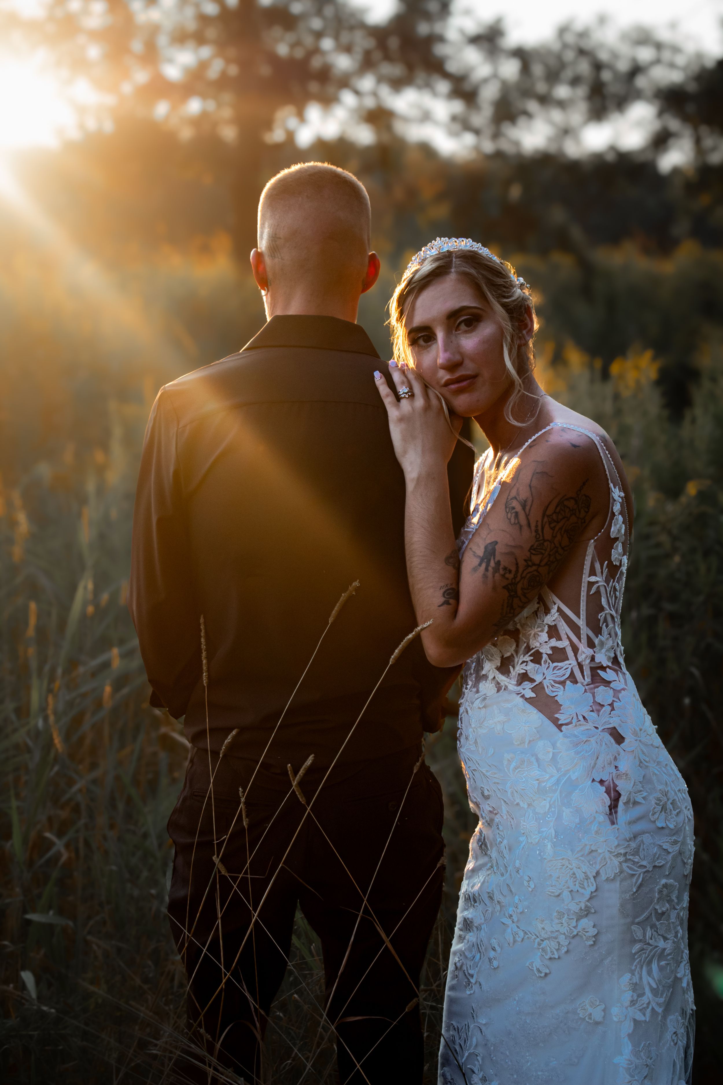 Professional wedding photography.  Couple on wedding day, wearing traditional wedding attire in prairie setting