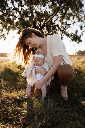 motherhood photographer capturing mum bending down to her baby and looking at her, christchurch