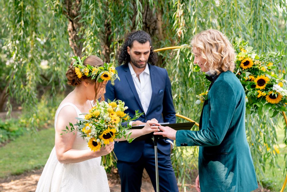 groom and bride exchanging rings