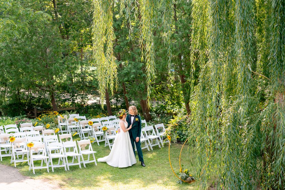 bride and groom hugging under willow tree before wedding