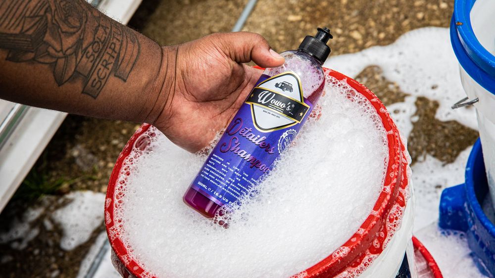 Car washing solution creating foam in a detail bucket.