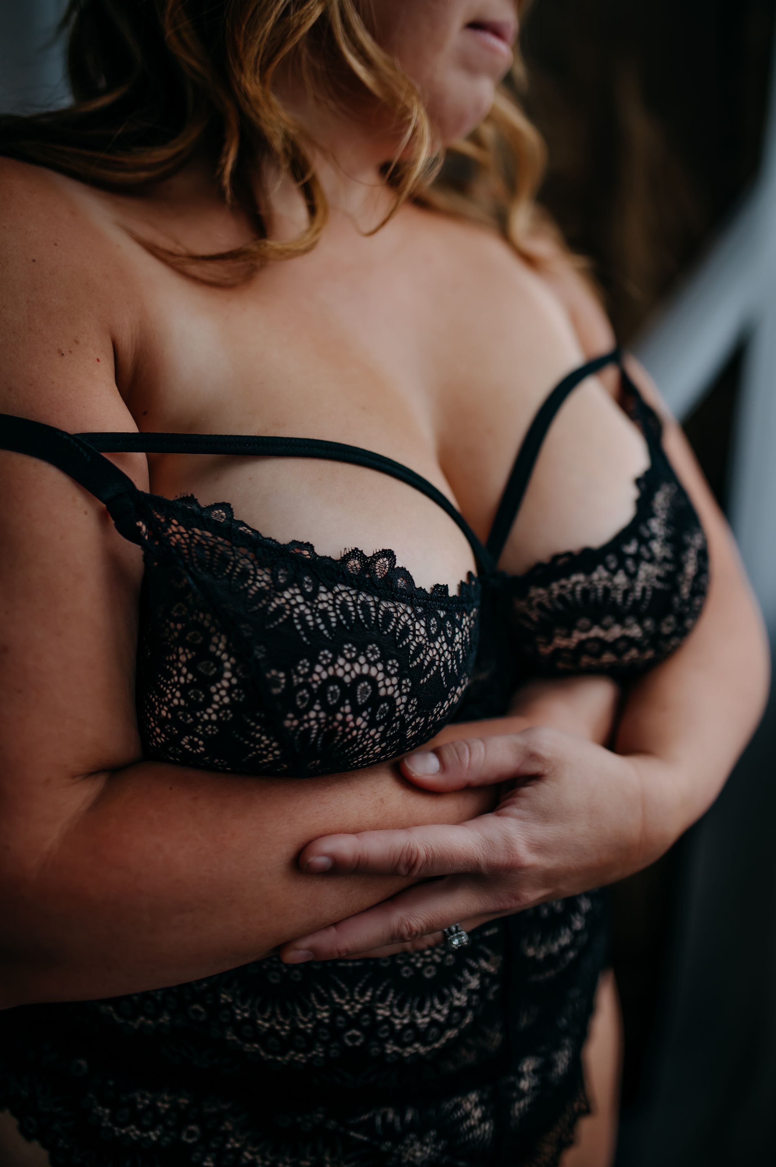 A series of cropped sensual boudoir photos showing black lace lingerie details against soft moody lighting.