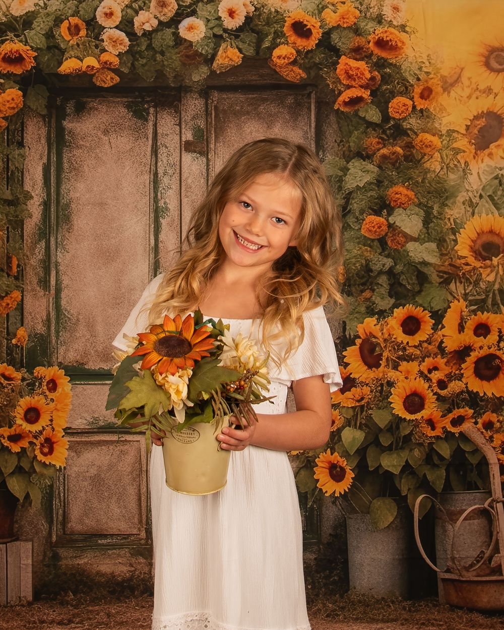 Sunflower garden portrait setting with vintage door and warm autumn colors.