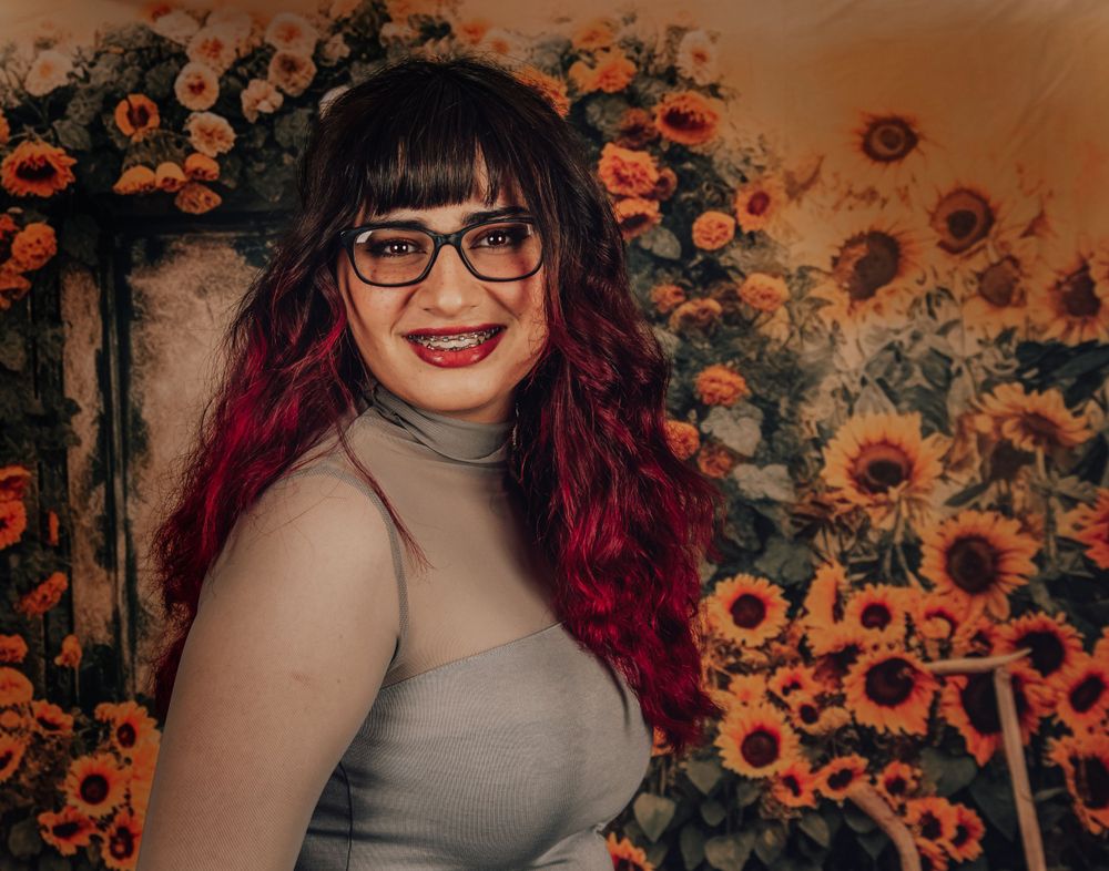 Autumn portrait with sunflowers and florals creating a warm backdrop.