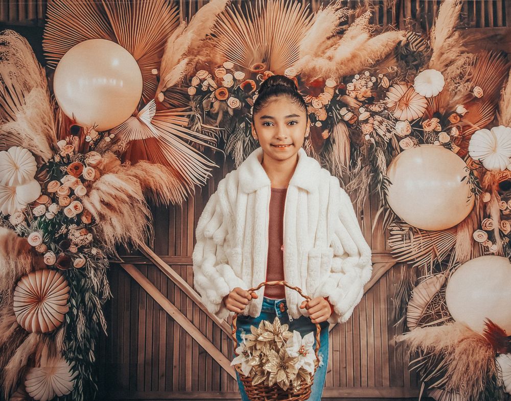 Boho party setup with dried flowers, white balloons, and warm-toned decorative elements.