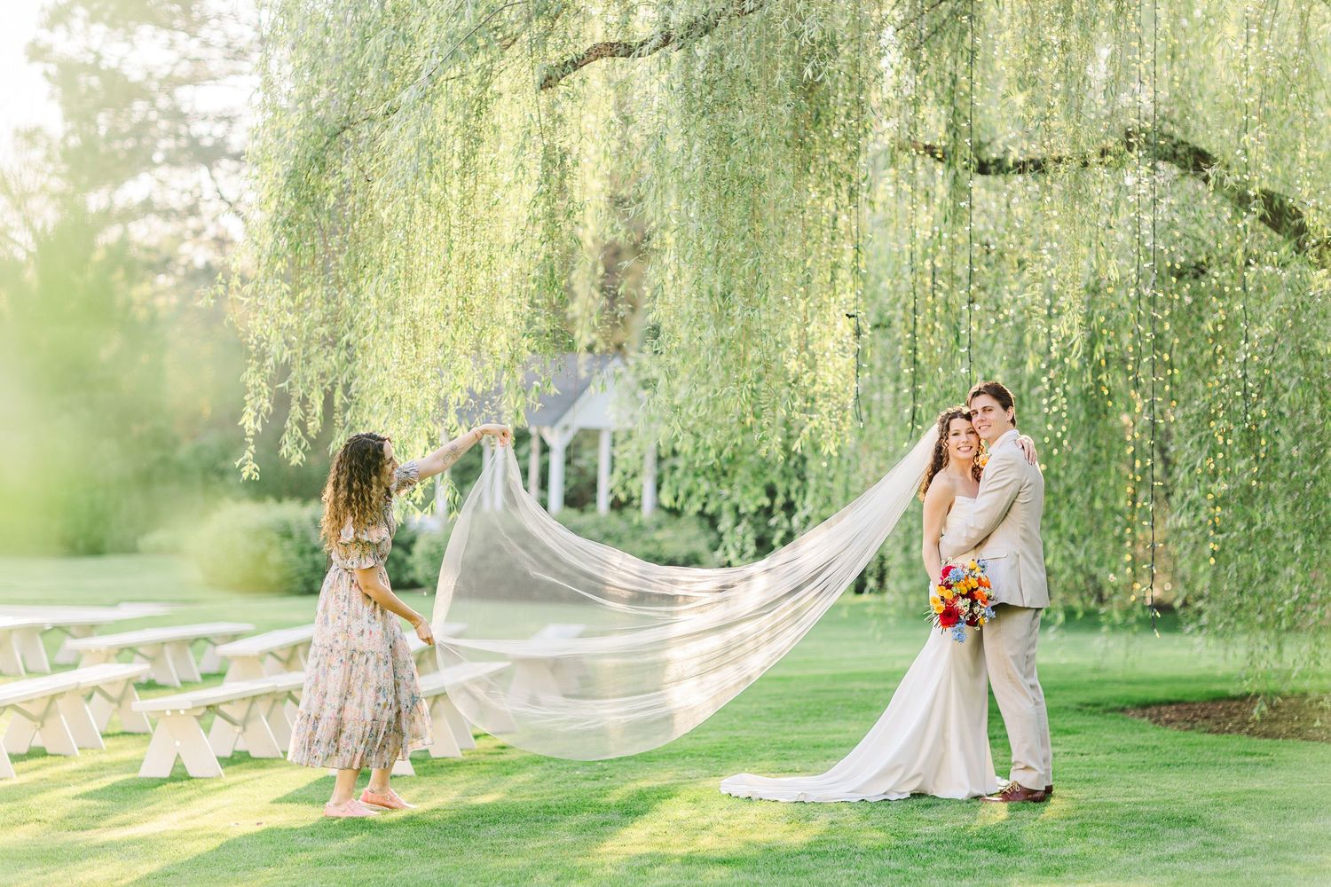 Wedding guests watching couple outdoors at intimate venue.