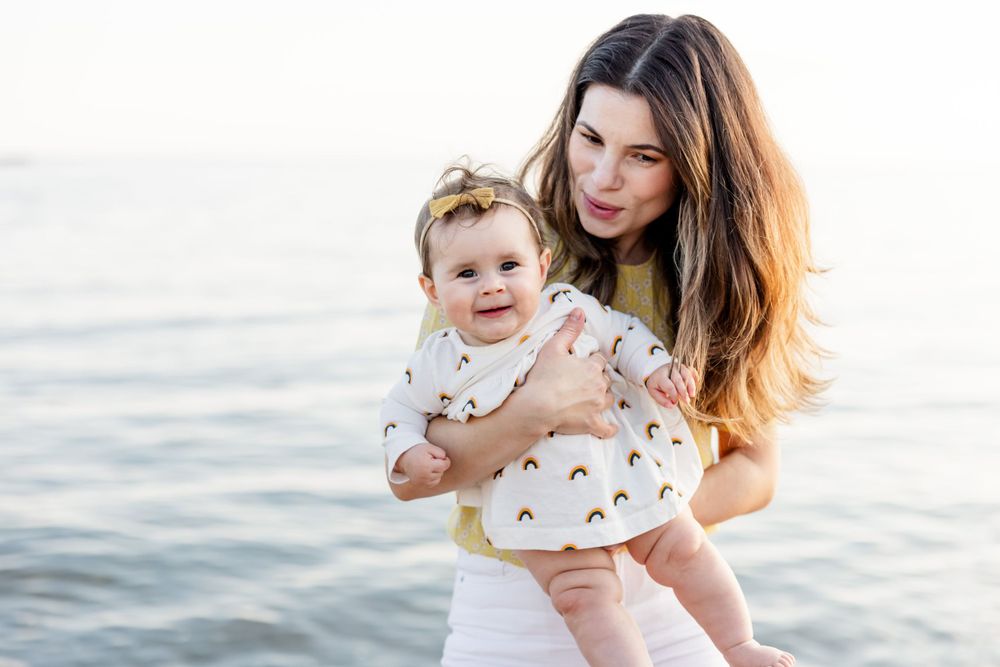 Candid family photography session at the beach during golden hour.