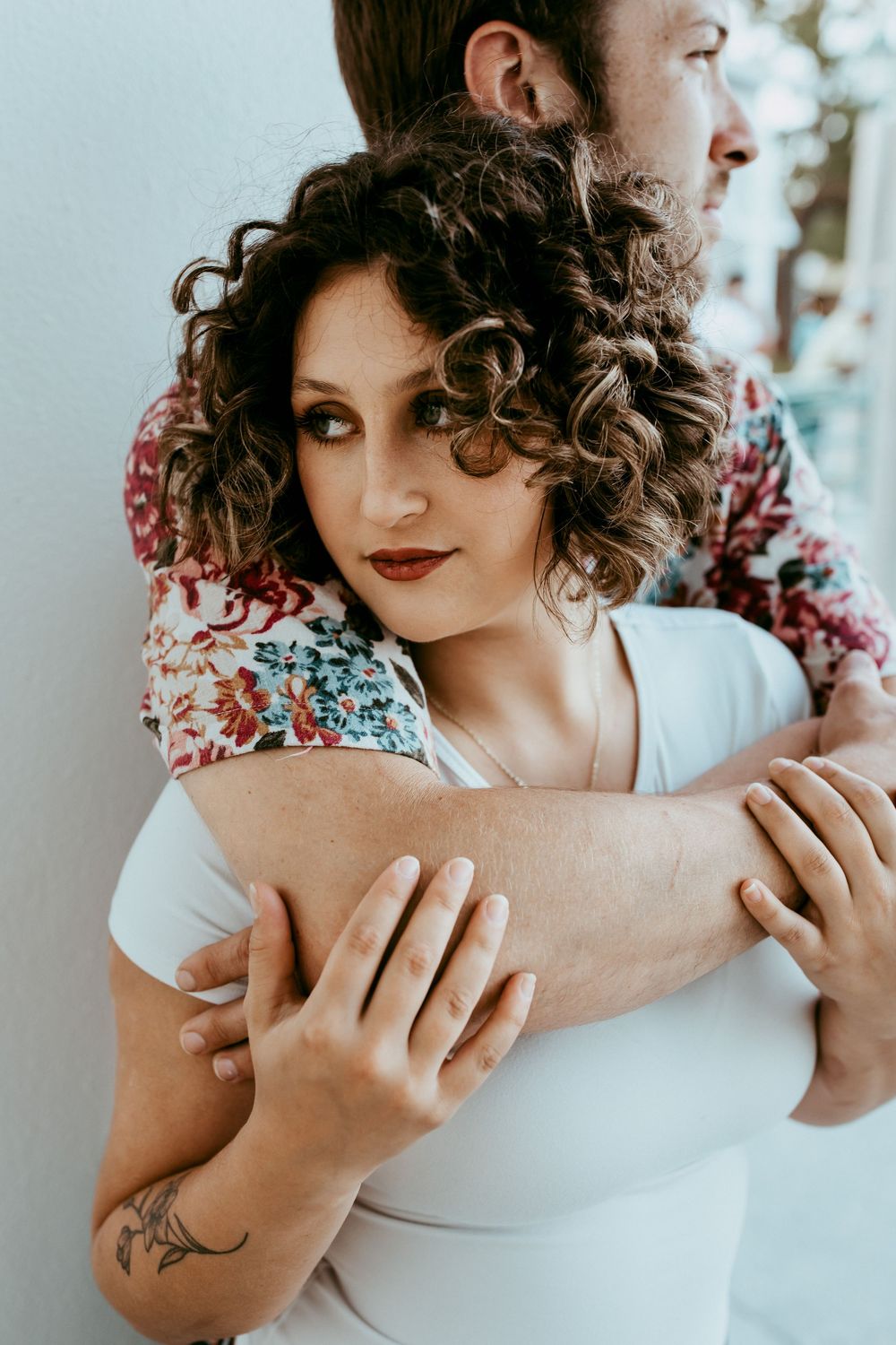 A series of intimate photographs showing hands, curls, and delicate movements in a soft white light artistic portrait setting.