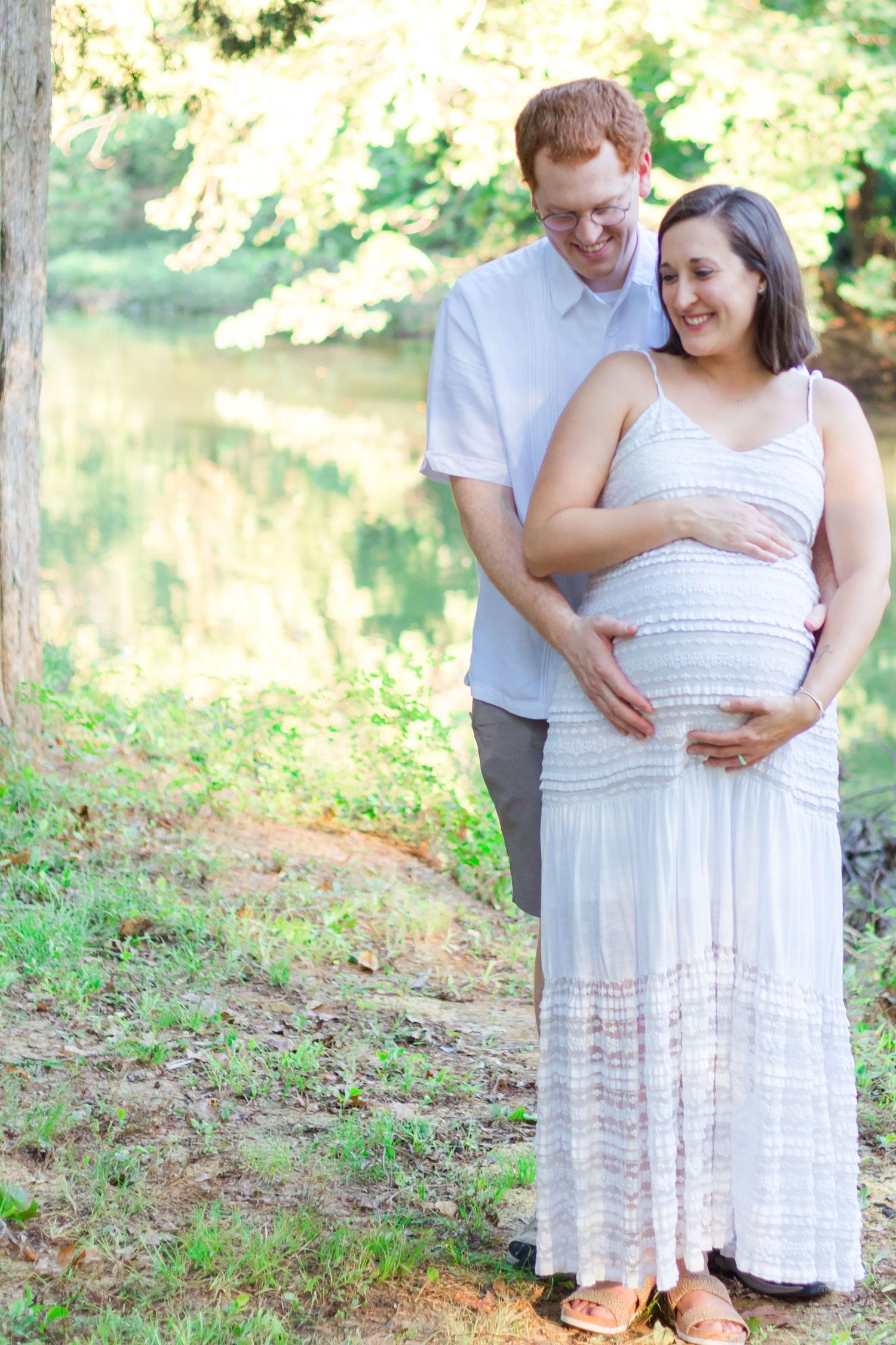 pregnant mother being embraced by husband
