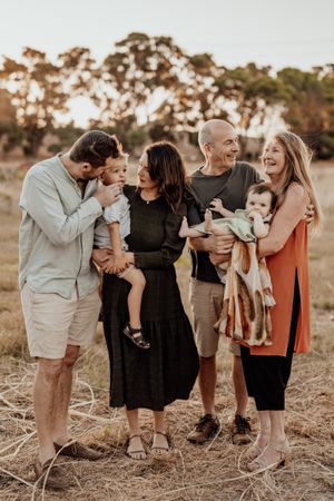 A candid family gathering outdoors during golden hour.