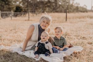 Candid family moments captured on a blanket during an outdoor photography session.