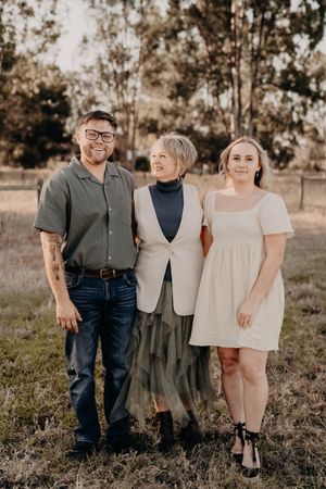 Family portrait session in a rustic outdoor setting during golden hour.
