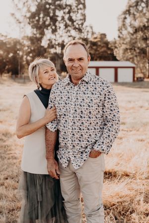 Natural and candid interaction between two people photographed in warm sunset lighting.
