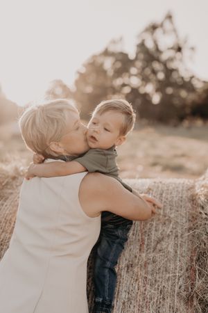Sweet embraces captured during outdoor family photo session at sunset.