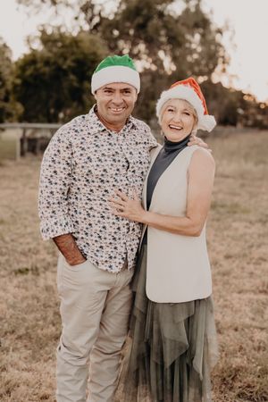 Holiday photo session with festive hats and candid poses in outdoor setting.