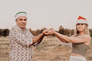 Holiday themed family photo session with casual poses on outdoor blanket.