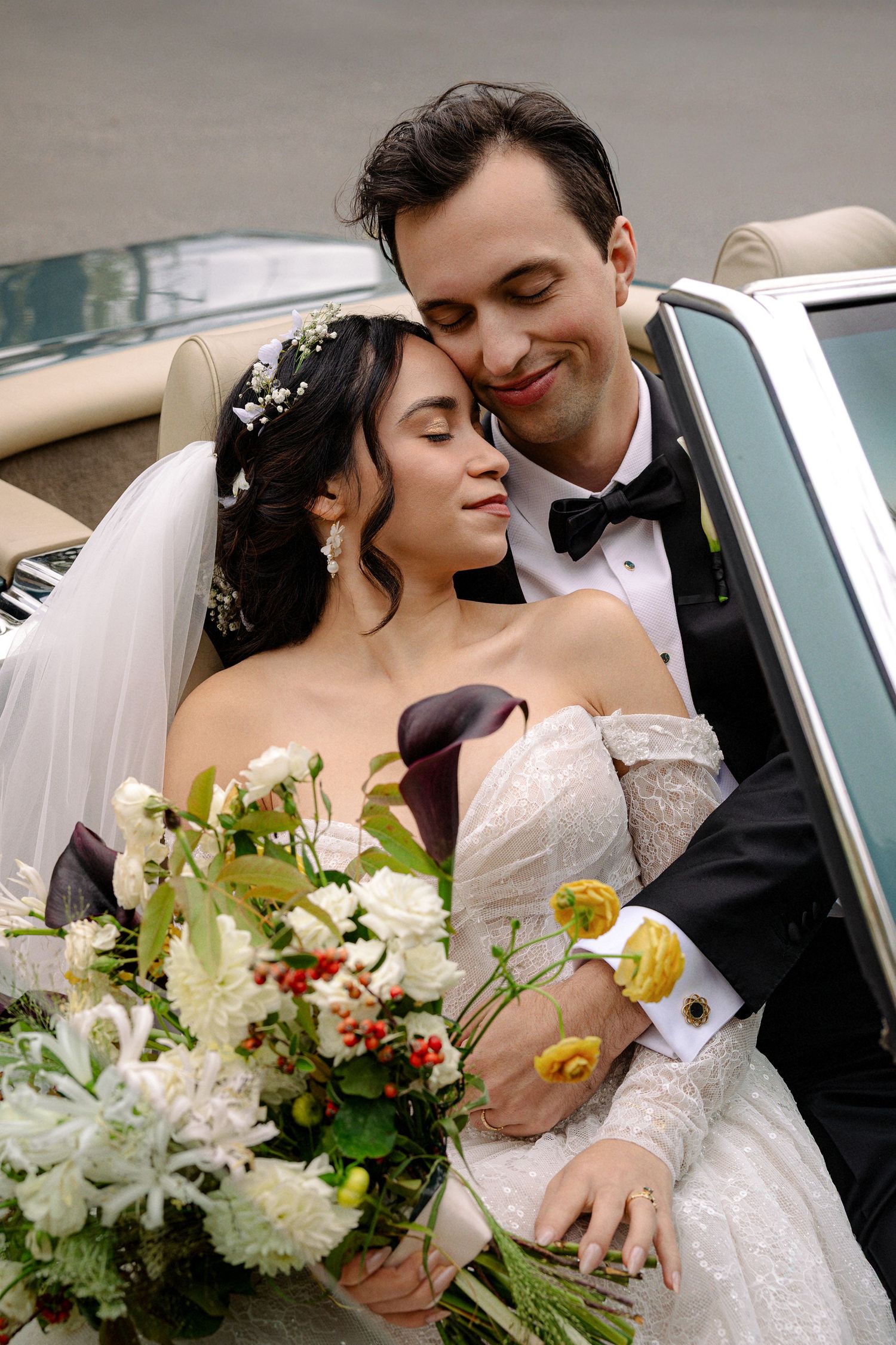 Happy couple cutting their wedding cake together during their reception celebration.
