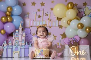 Princess castle themed first birthday photo session with pastel balloons and gold stars.