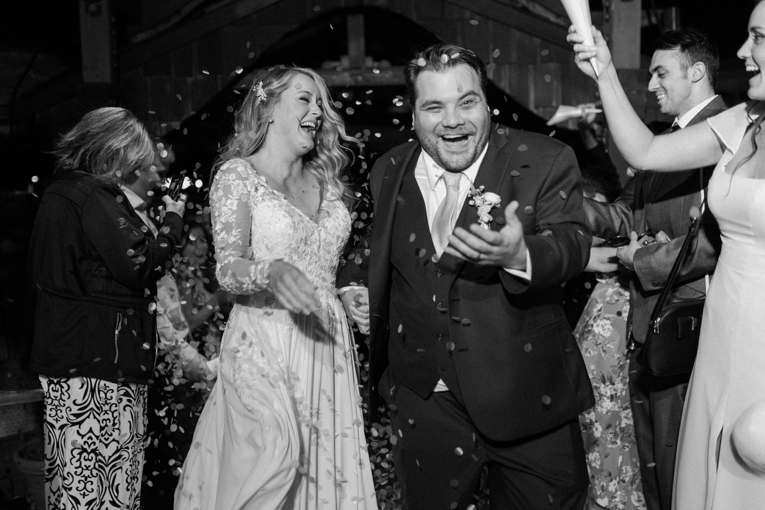 A wedding celebration with dancing and confetti in a rustic venue.