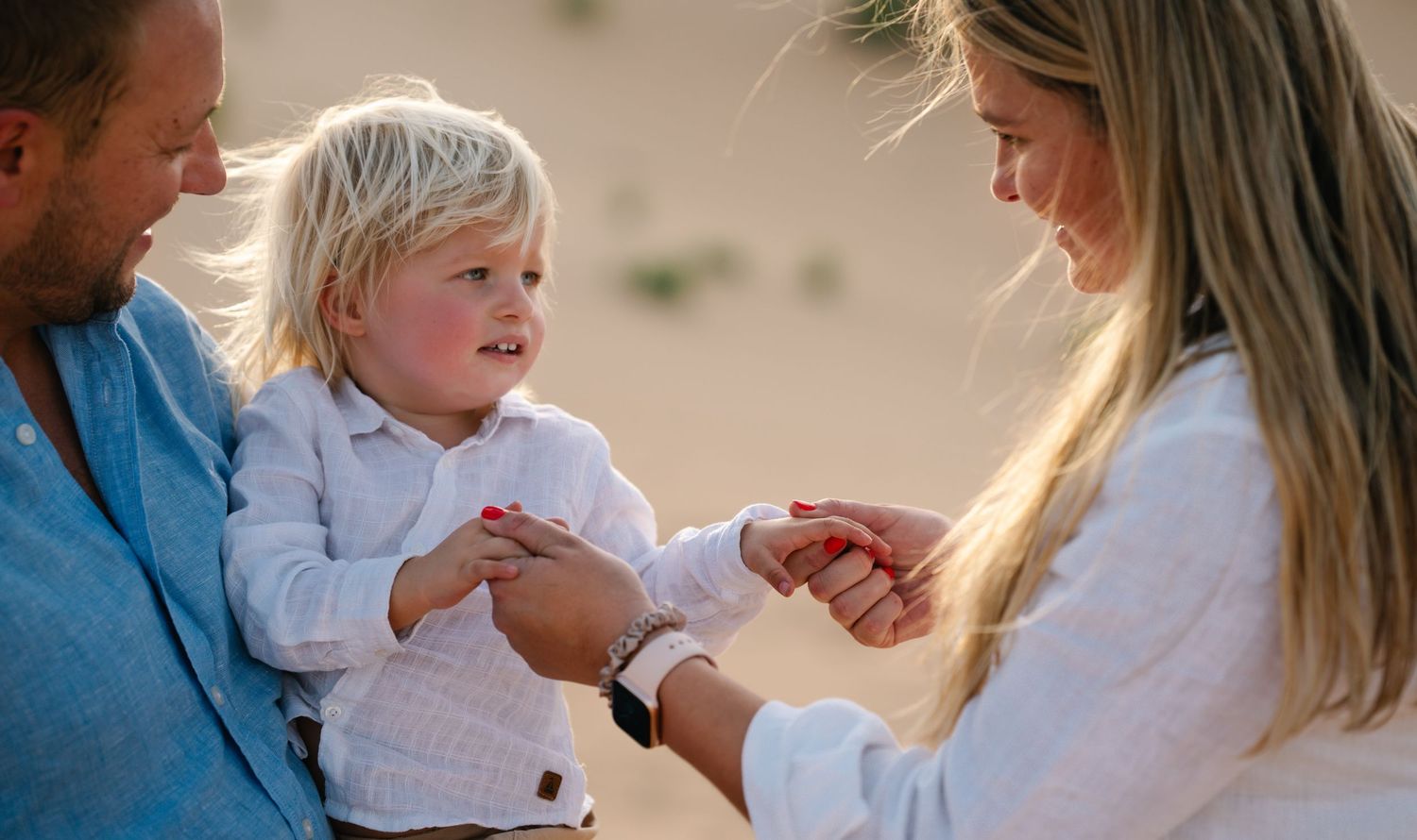 Family enjoying a casual outdoor photoshoot in casual attire with natural expressions.