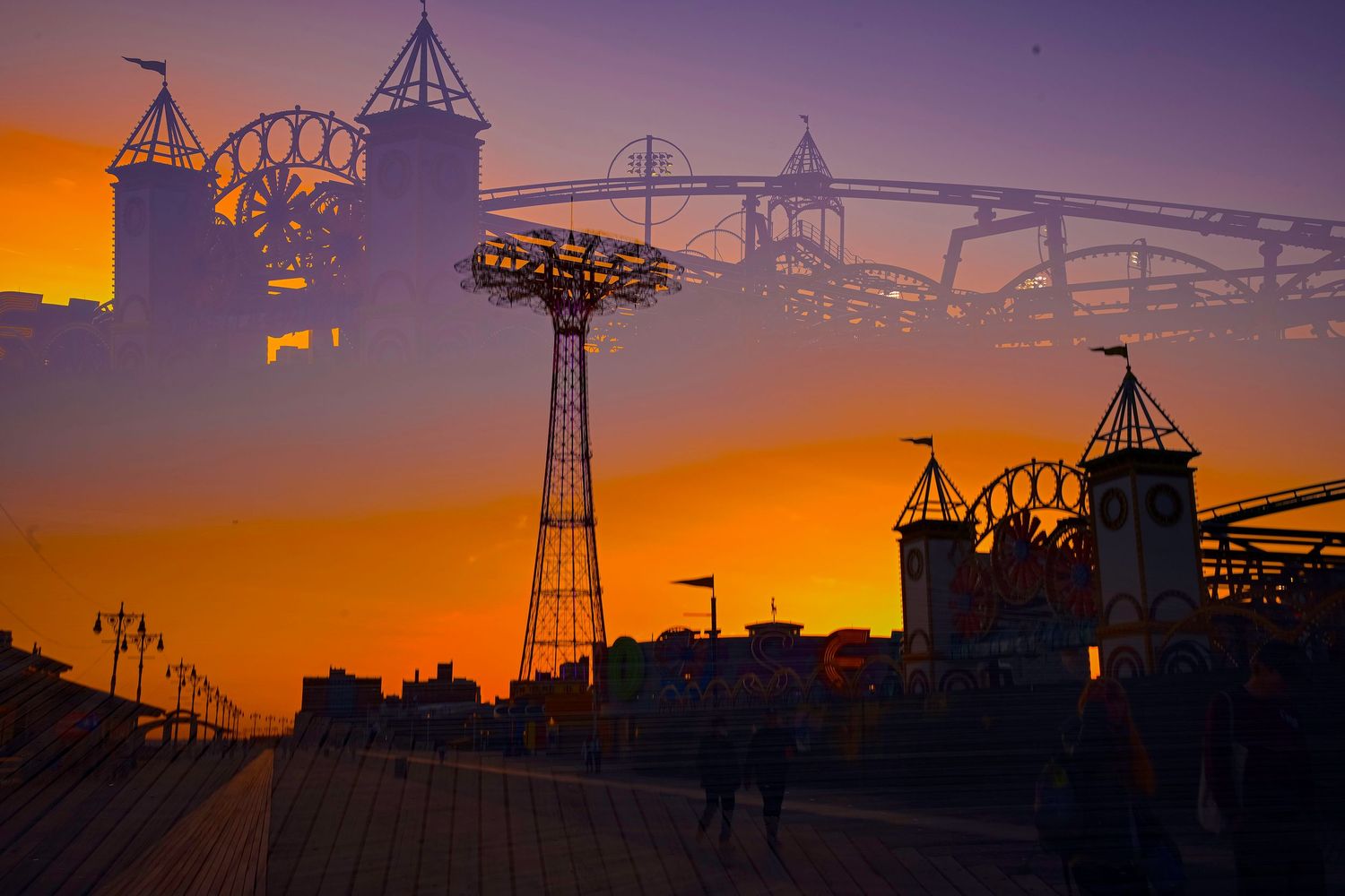 Dramatic sunset silhouettes Coney Island's famous rides and attractions against an orange sky.