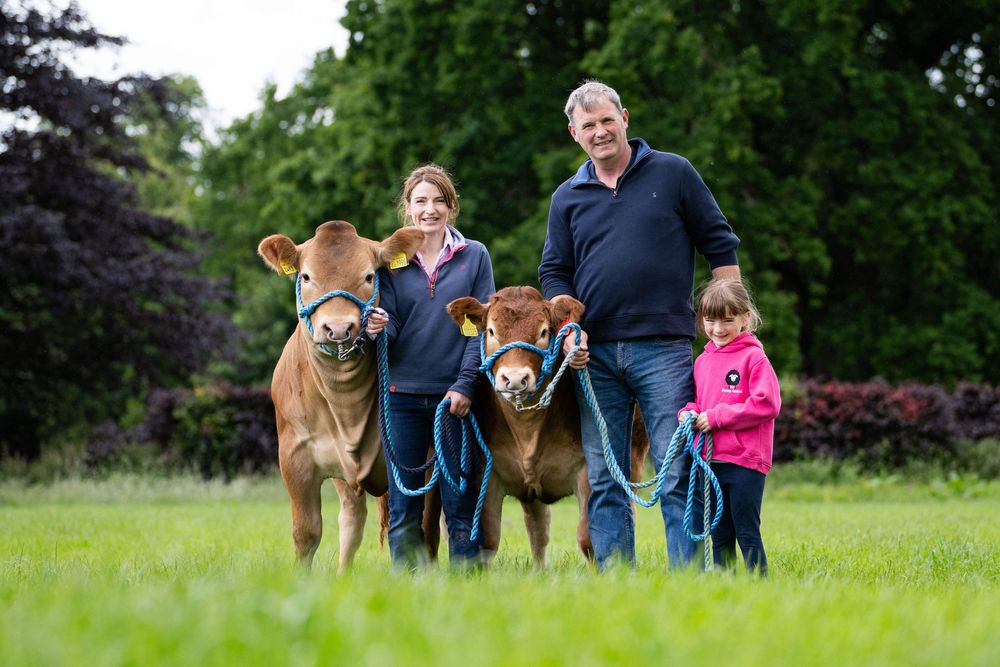 Mum and Dad and child with cattle