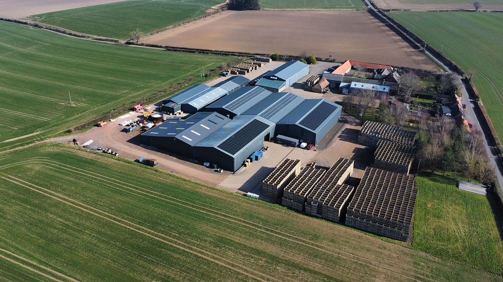 drone shot of farm shed with solar panels