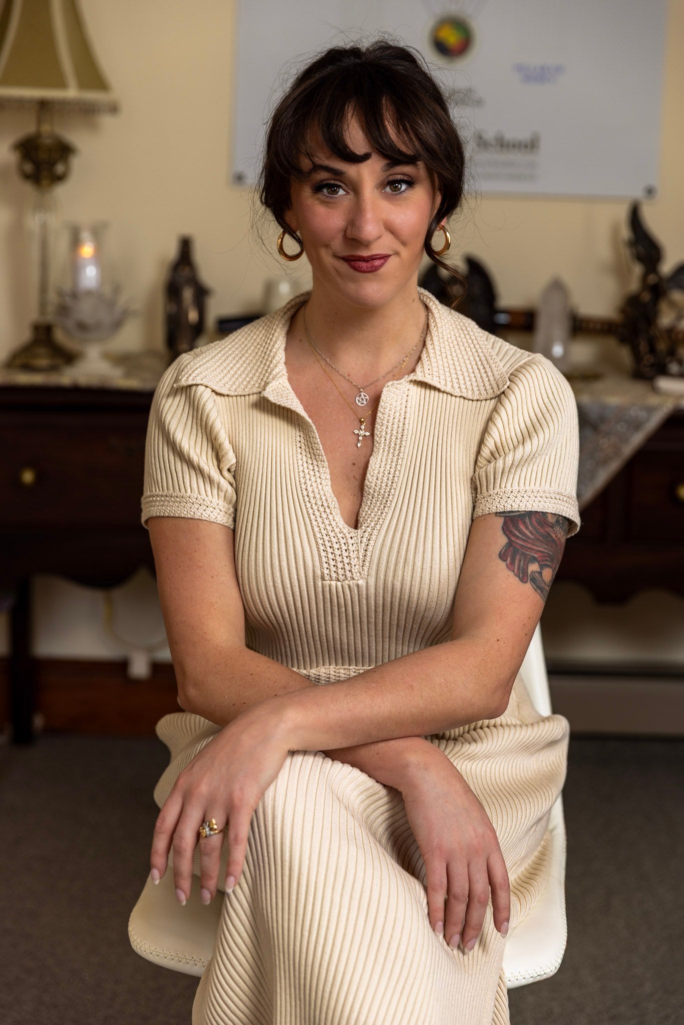 Portrait series in cream colored vintage-style dress against indoor setting.