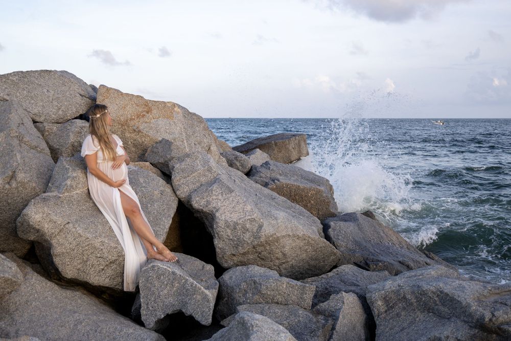 dramatic Maternity shoot with flowy dress at Fort Lauderdale Beach during sunset, taken by Wanderlust Studios