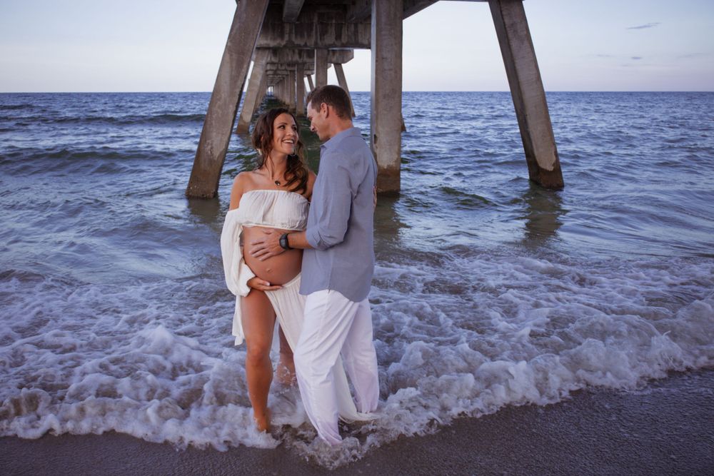 Dramatic pier shot for maternity shoot in Deerfield Beach florida, taken by wanderlust studiosty