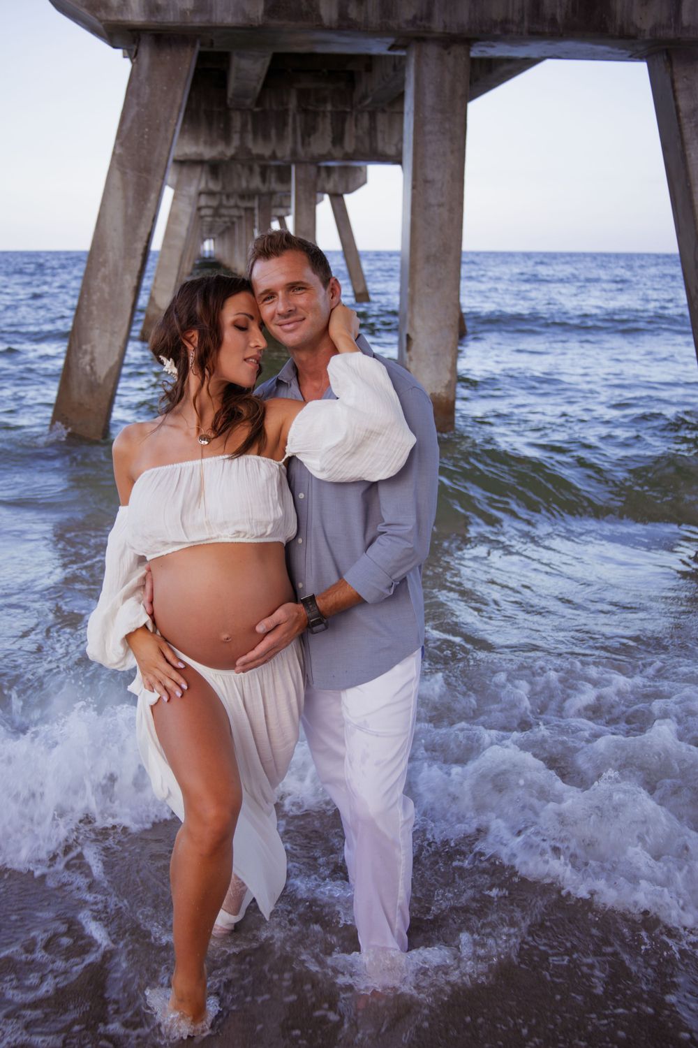 Dramatic pier shot for maternity shoot in Deerfield Beach florida, taken by wanderlust studios